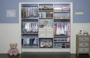Custom kids closet with white built in shelves.