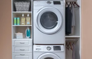 Custom Laundry cabinets frame a stacked washer and dryer