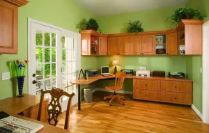 Home office with plenty of desk space and overhead cabinets for office supplies and books
