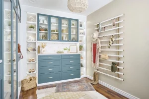 Walk in closet with drawers, cabinets, and hooks