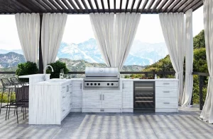 Outdoor cabinets with built in grill top and white curtains attached to a wooden frame