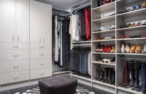 Custom Walk in closet with shelving for shoes and a large shelf at the bottom for tall boots