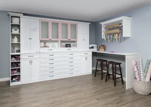Kitchen cabinets and drawers with adjacent bar counter and stools