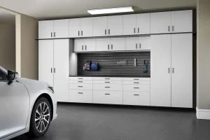 White Cabinets with Ebony Star workbench. A car is parked in the garage