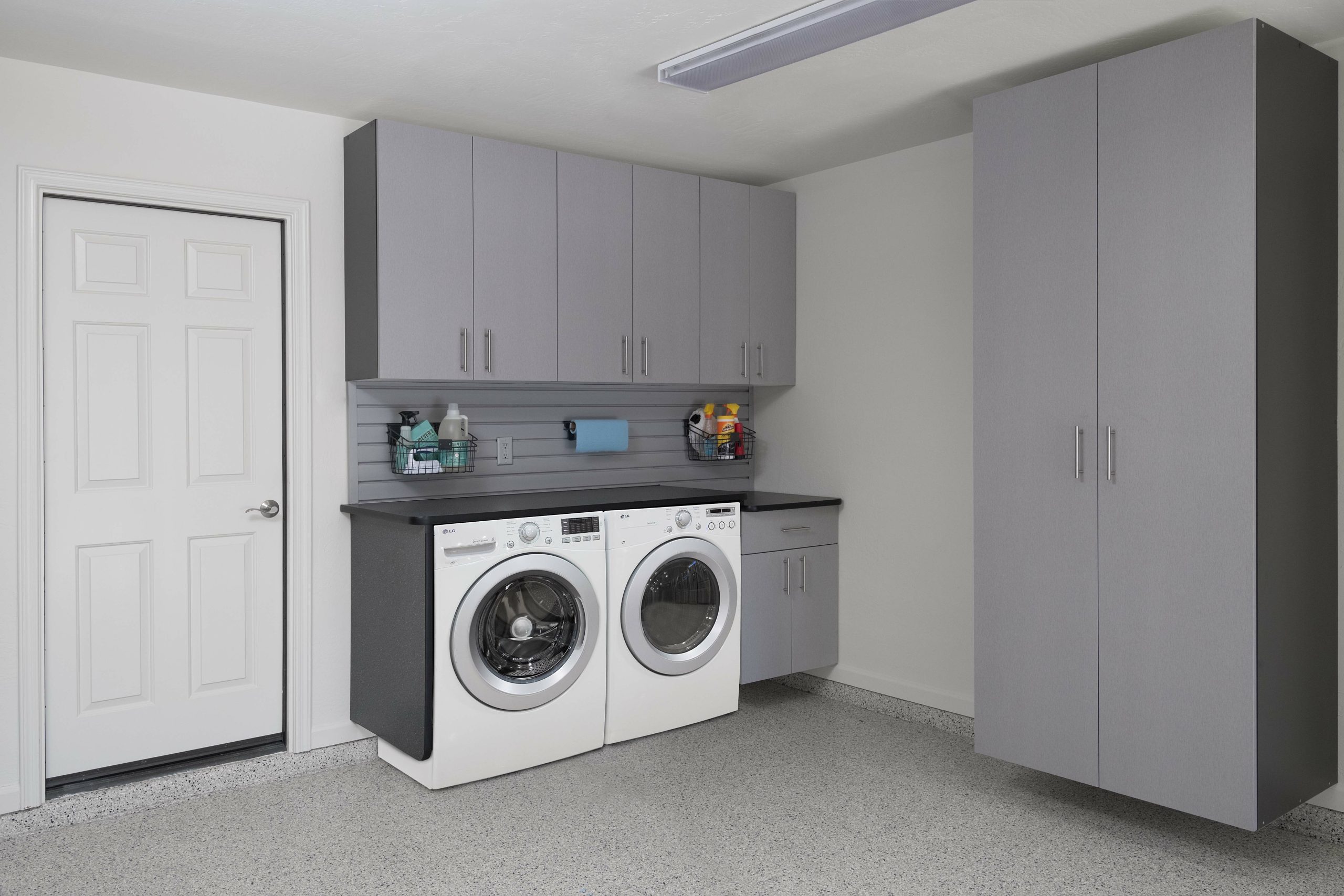 Grey custom cabinets in a neatly organized garage. 