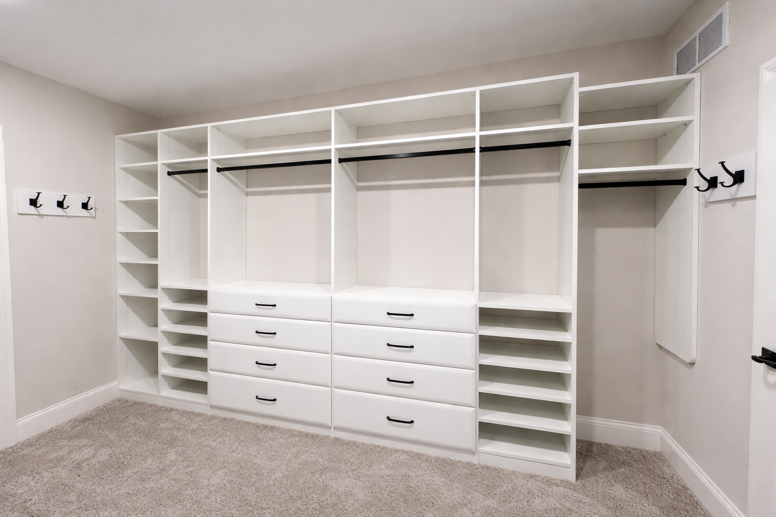 Custom closet solution with white built in shelves and drawers
